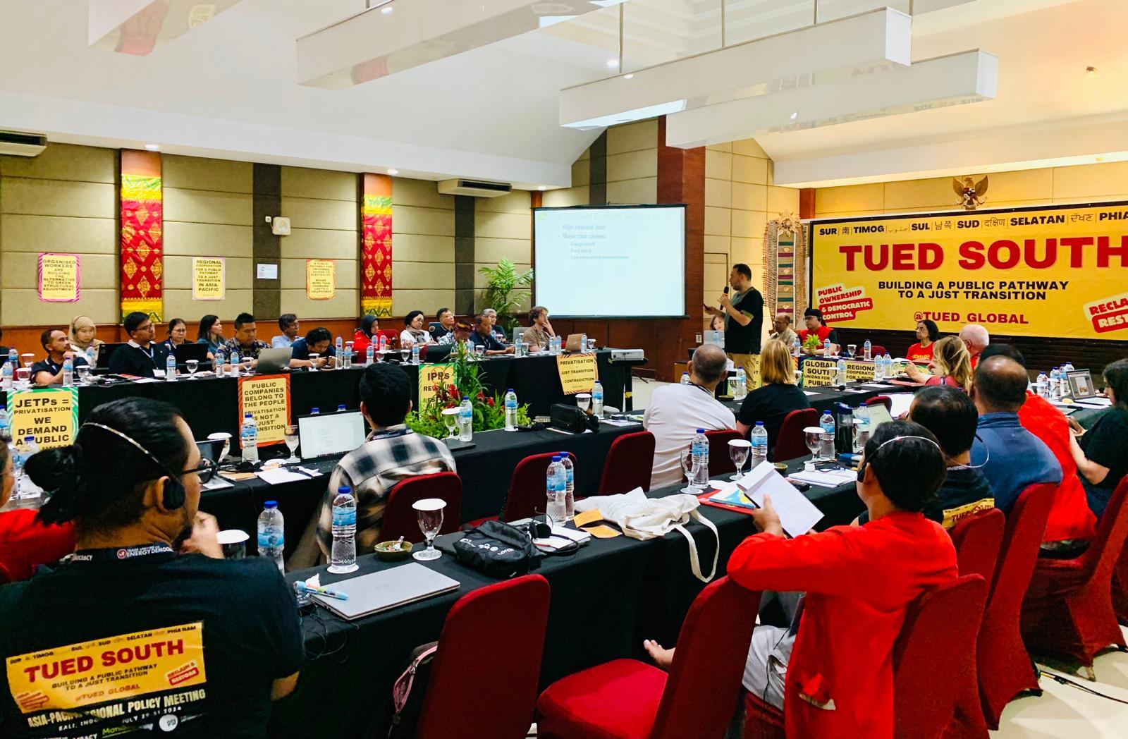 TUED South Asia-Pacific plenary in Bali — delegates at tables before the Building a Public Pathway banner