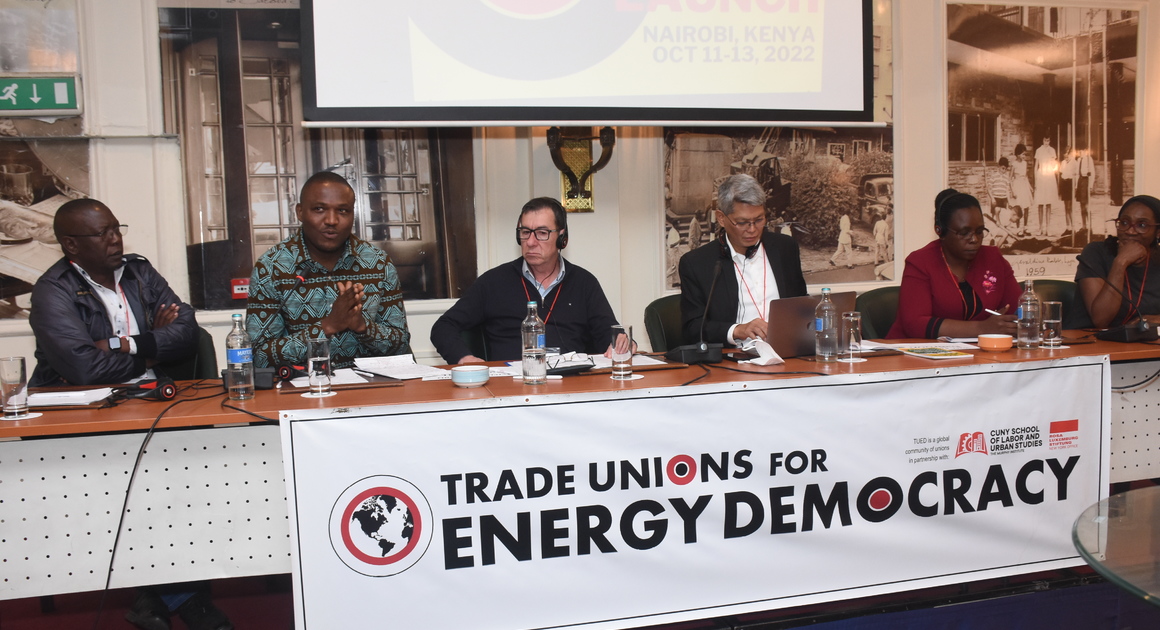 Panel of union leaders at the TUED meeting in Nairobi, October 2022, behind a Trade Unions for Energy Democracy banner